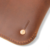 close up of bottom corner of clutch with rustico logo
