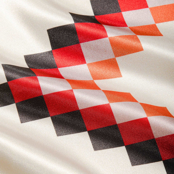 close up of rag with black, red, white, and orange zig zags