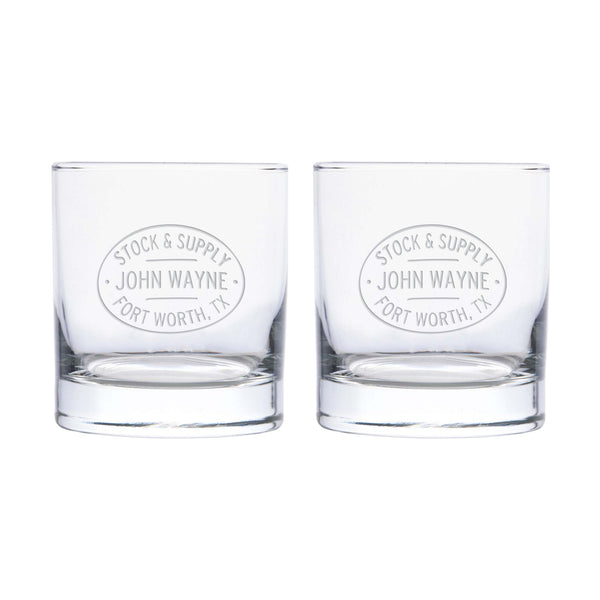 two whisky glasses with "stock & supply John Wayne Fort Worth, TX" etched on it 