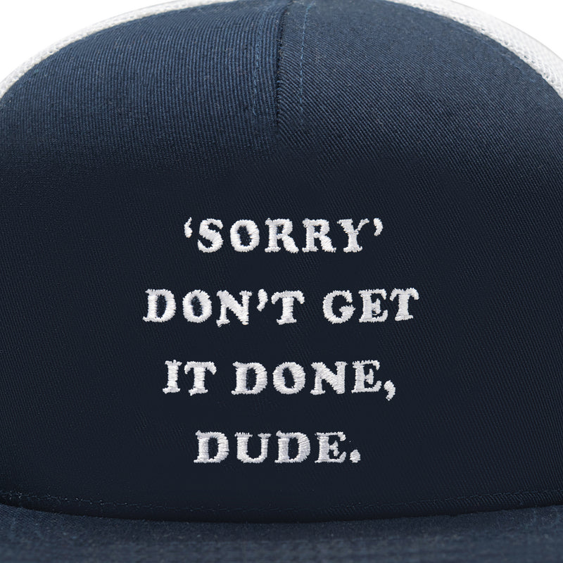 close up of navy and white hat with "sorry don't get it done, dude."