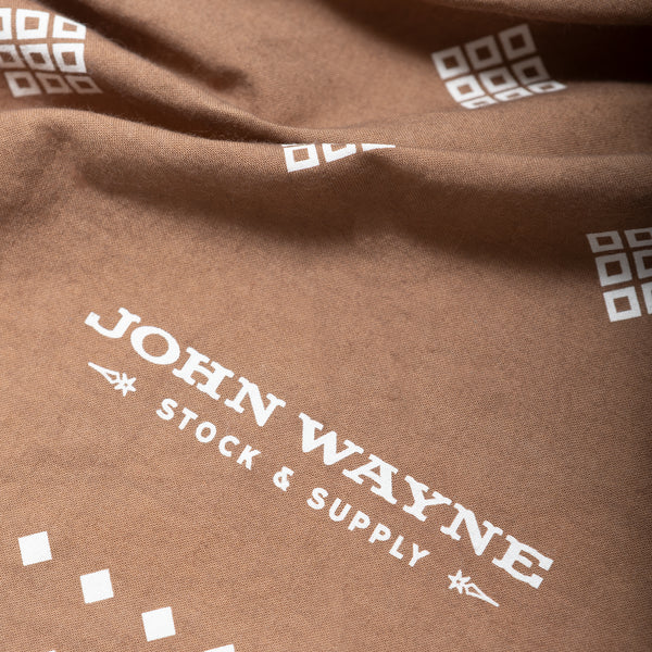 close up of john wayne stock & supply on corner of bandana 