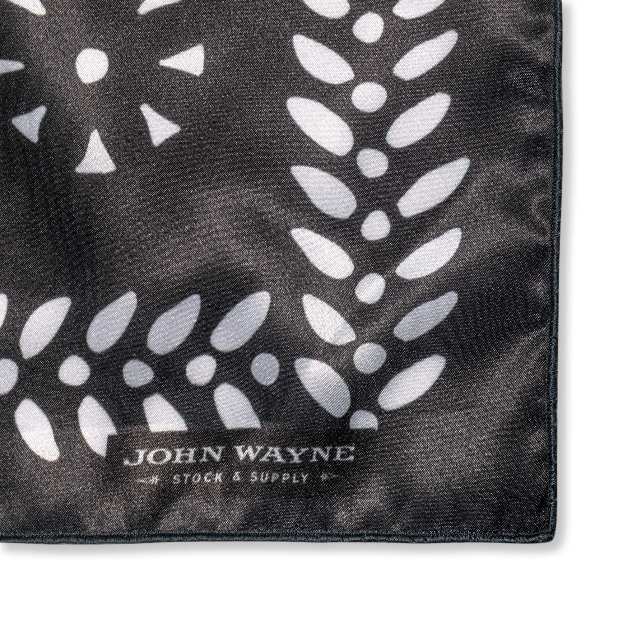 close up of corner of rag with small "john wayne stock & supply"  text 