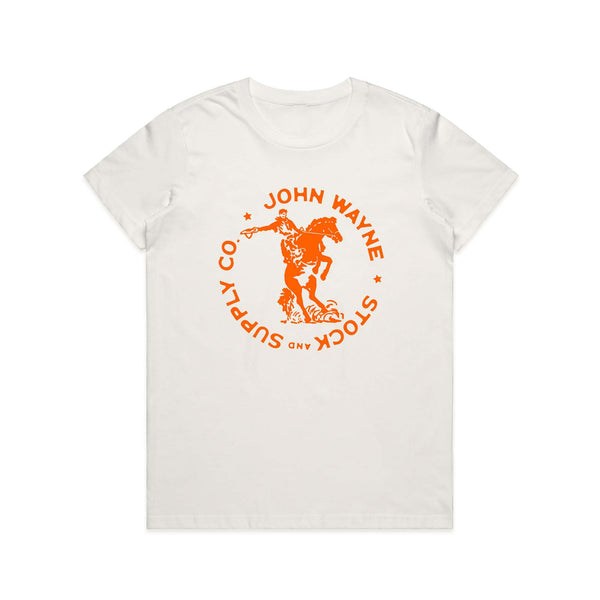 front of white women's t-shirt with orange john wayne on a bucking horse and "john wayne stock and supply co." bordering it design
