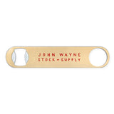 back of bottle opener with "john wayne stock + supply" on it