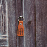 leather john wayne western goods keychain on nail in wall