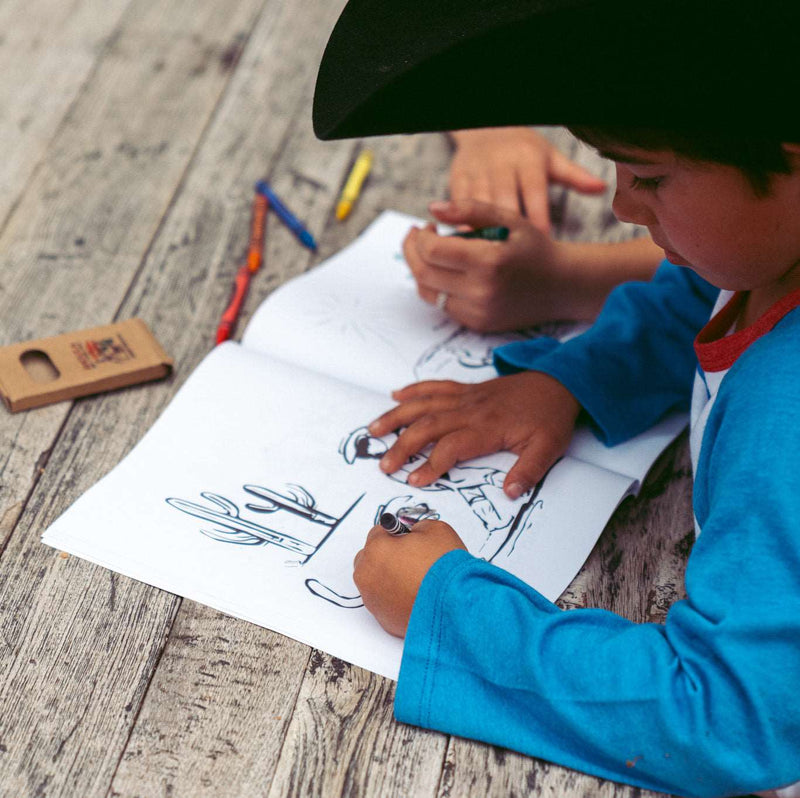 little boy coloring in john wayne coloring book 