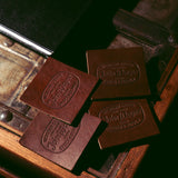 4 leather western goods john wayne texas stock & supply coasters on wood table 