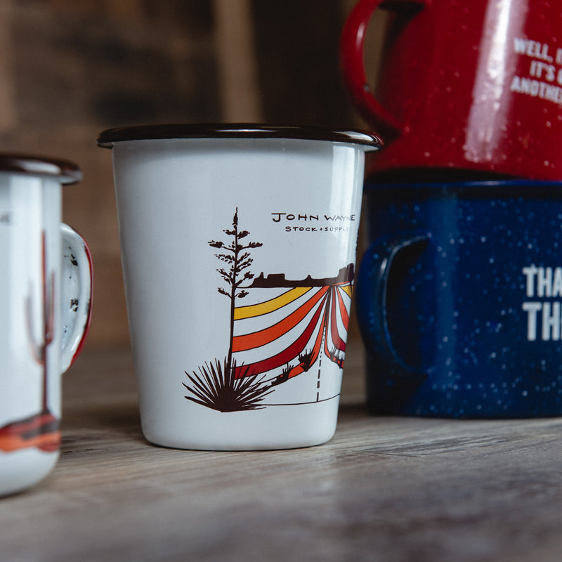 coated tumbler cup with Classic JW Monument Valley Scenery on wood next to other john wayne cups