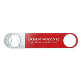 red bottle opener with "john wayne stock & supply" on it