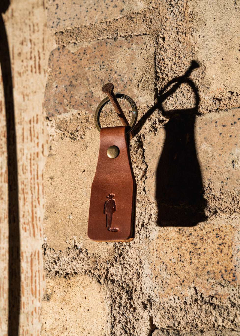 john wayne silhouette leather keychain hanging on nail