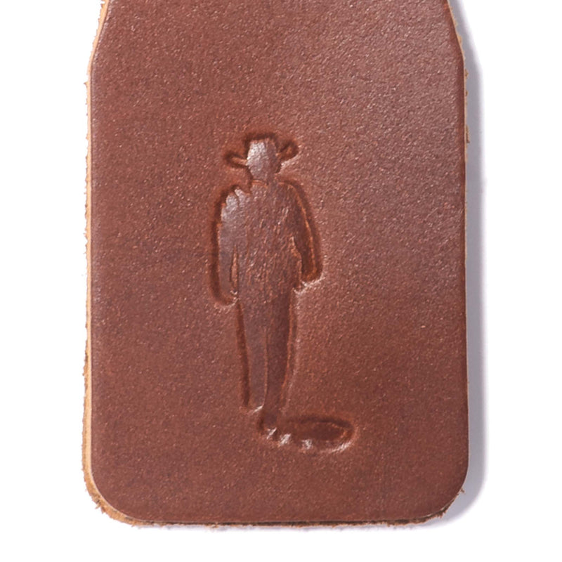 close up of john wayne silhouette on leather keychain 