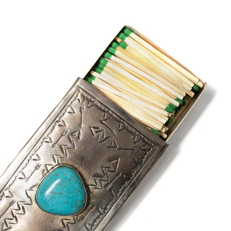 match box with turquoise stone on top opened with matches in it