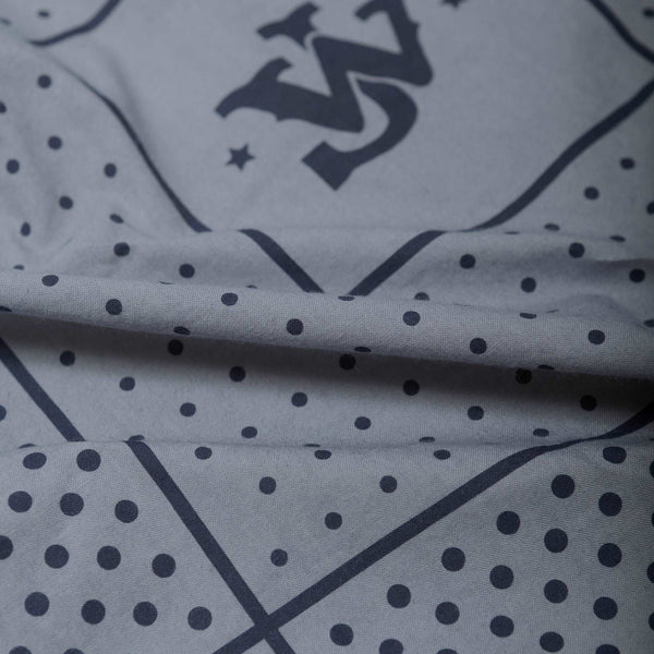 close up of  john wayne initials and dots pattern around it