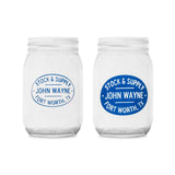 two glass mason jars with "stock & supply John Wayne Fort Worth, TX" on them