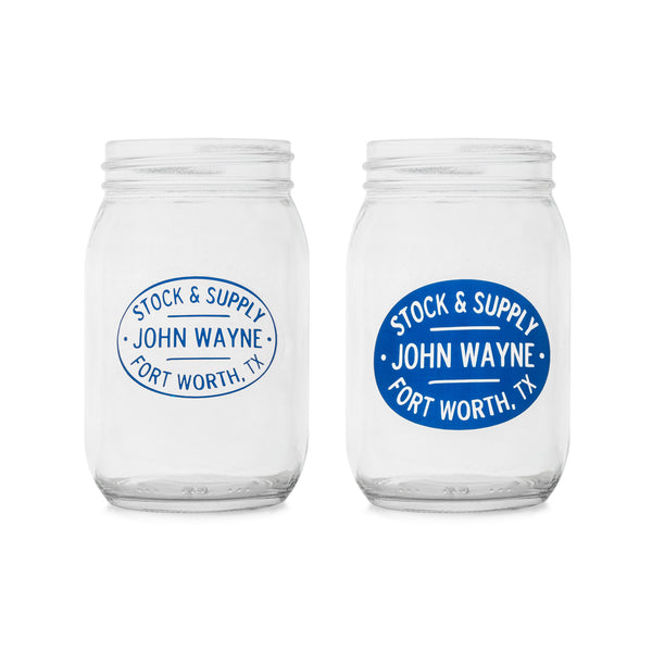 two glass mason jars with "stock & supply John Wayne Fort Worth, TX" on them