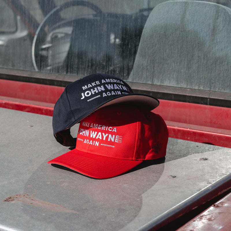 red and navy make american john wayne again hats stacked on top of each other