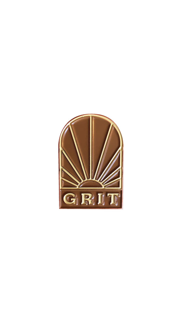 pin with sun and "grit" below it
