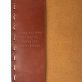 inside of notebook with "words are what men live by...words they say and clean" engraved in leather